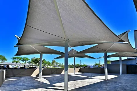 View beneath peaked umbrellas and central supports.