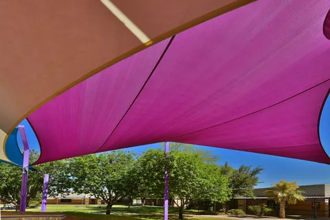Close view of purple and light shade fabric and supports.