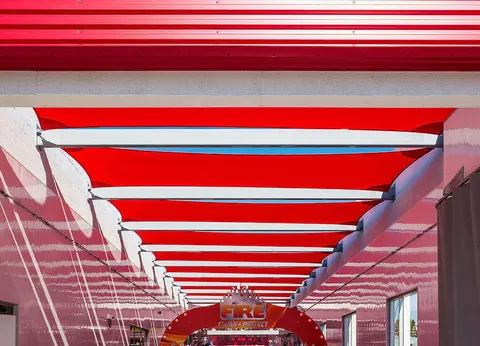 Repeated red shade panels above a car-wash vehicle area.