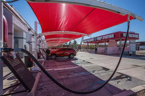 Red shade panels above car-wash vacuum stations.