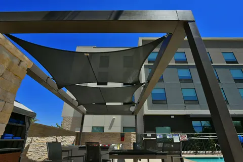 Upward view of shade panels within a freestanding frame.