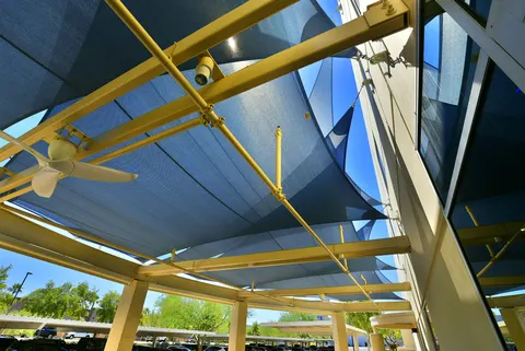 Upward view of shade-panel framing and fabric connections.
