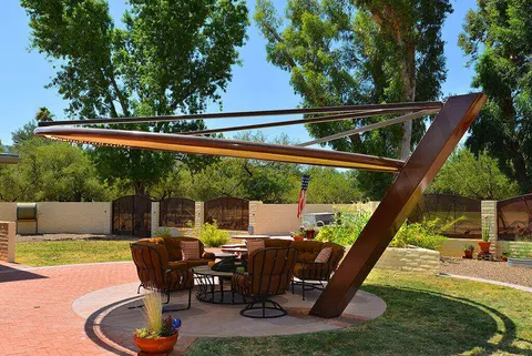 Side view of a cantilevered patio umbrella beside a pool.