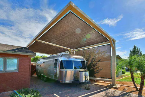 Upward view of a peaked canopy above a travel trailer.